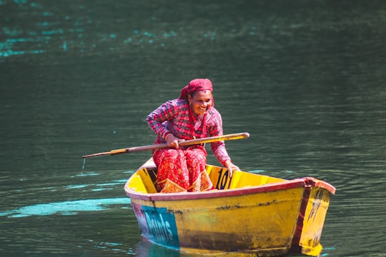 smiling woman on canoe in Begnas Lake Nepal