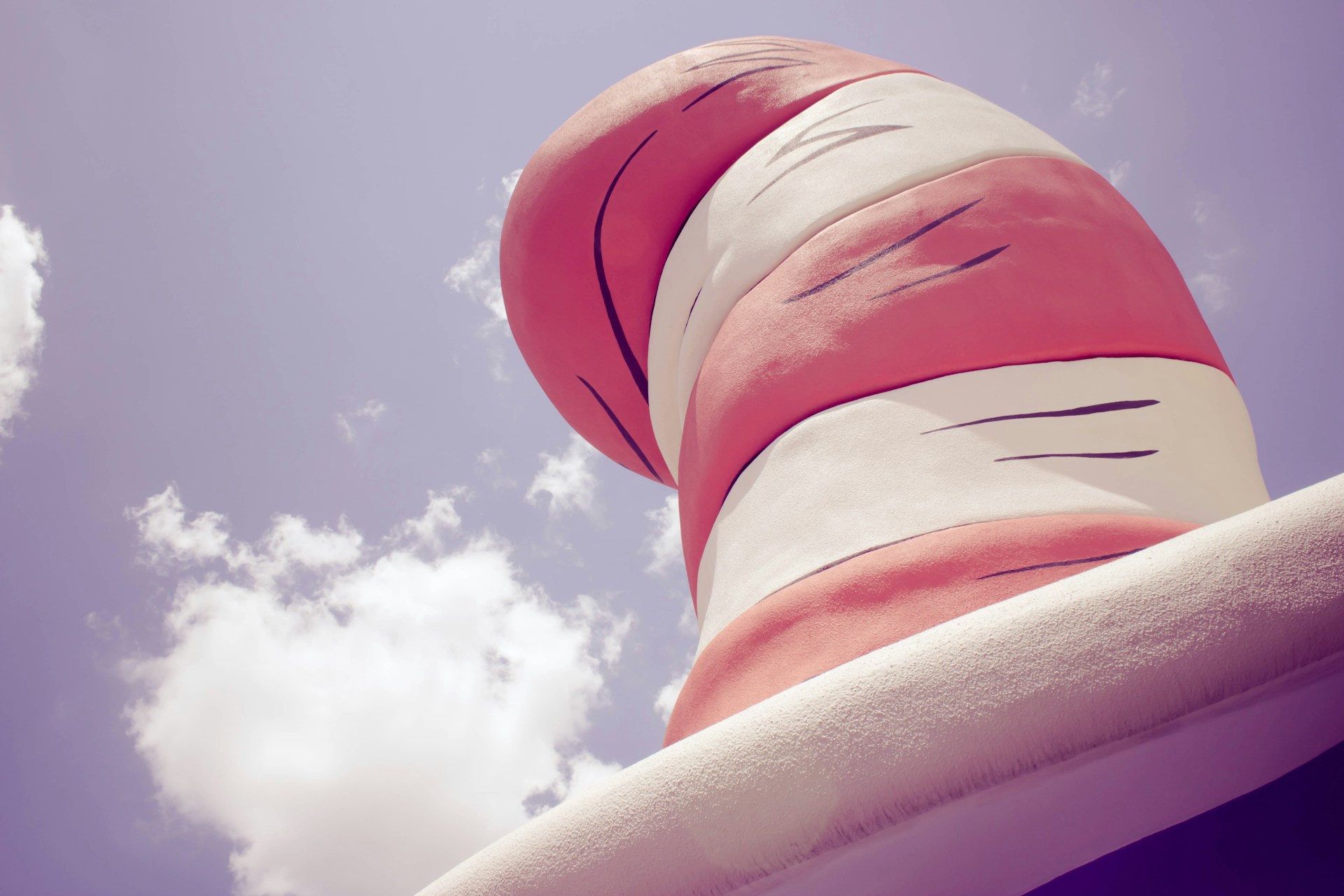 woman wearing yellow long-sleeved dress under white clouds and blue sky during daytime