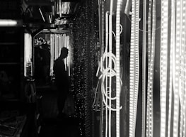 A dark alleyway illuminated by flickering holograms, evoking a futuristic noir atmosphere.