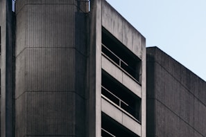 A striking brutalist building in Tijuana showcasing raw cast-in-place concrete textures under bright sunlight