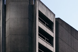 A striking brutalist building in Tijuana showcasing raw cast-in-place concrete textures under bright sunlight