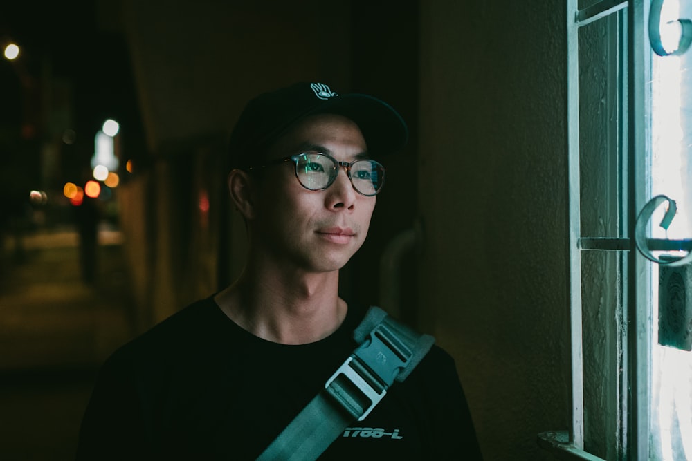 man standing beside window