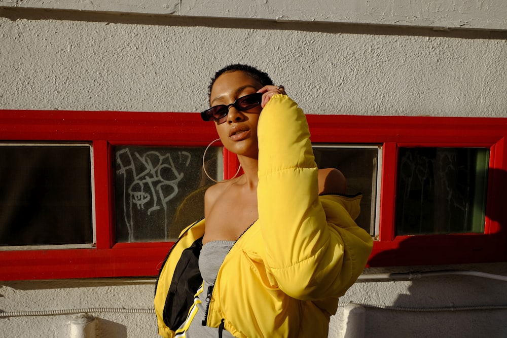 woman holding her sunglasses