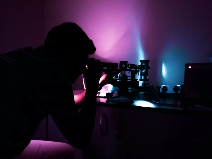 Close-up of a scientist carefully examining a peptide certificate of analysis under lab lighting.
