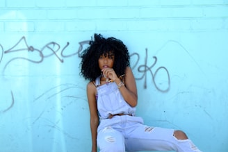 woman leaning on blue wall
