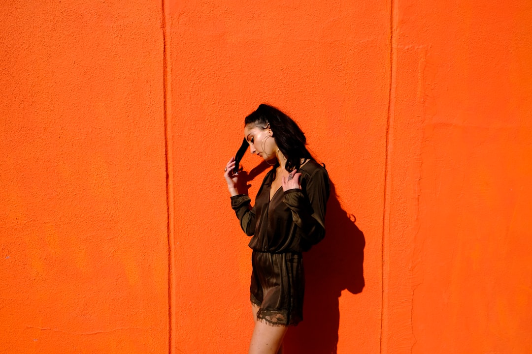 woman near orange wall