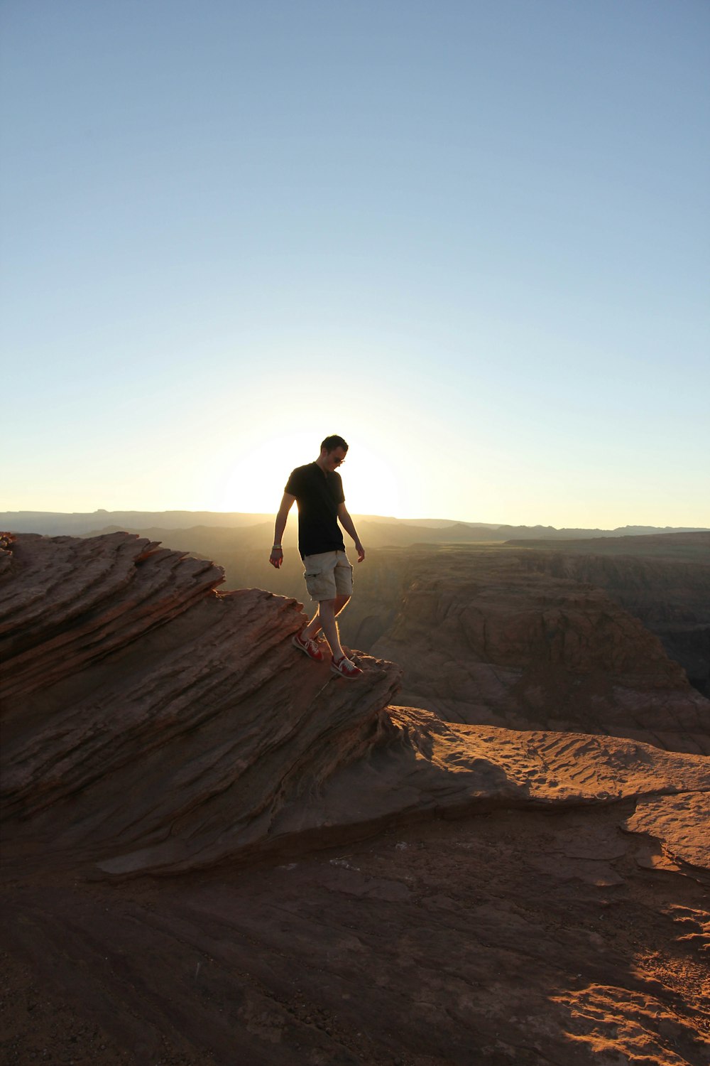 man standing uptop of a mountain