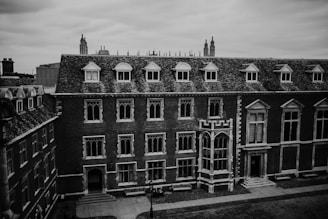 A historic brick library with large arched windows.