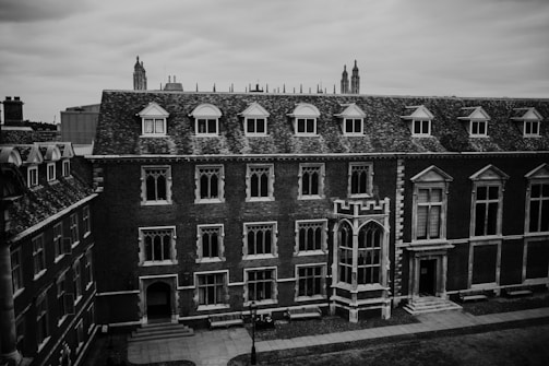 A historic brick library with large arched windows.