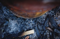 Close-up of a hand inspecting a barrel's charred surface, highlighting the craftsmanship behind each pick.