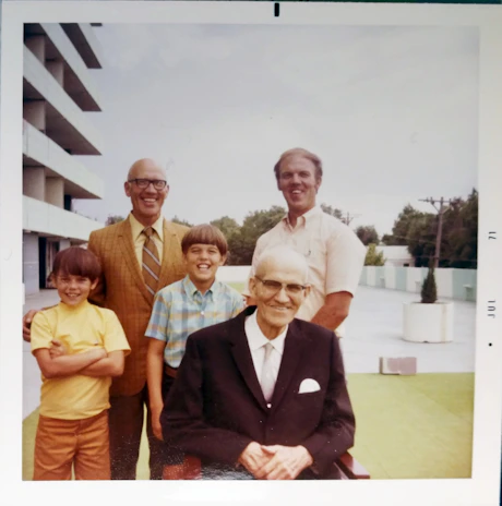 A group photo of village head and staff standing in front of the village office.