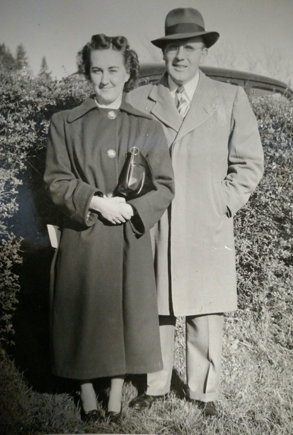 grayscale photography of man and woman wearing coat