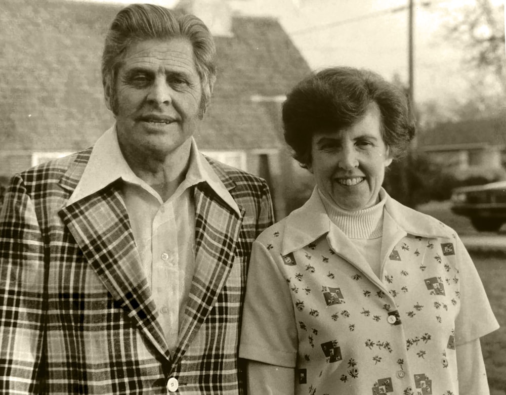 grayscale photography of smiling man and woman