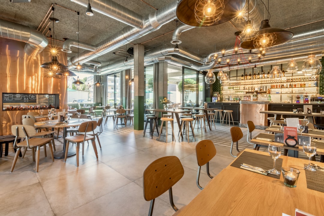 brown wooden tables and chairs inside building, Industrial chic restaurant & bar