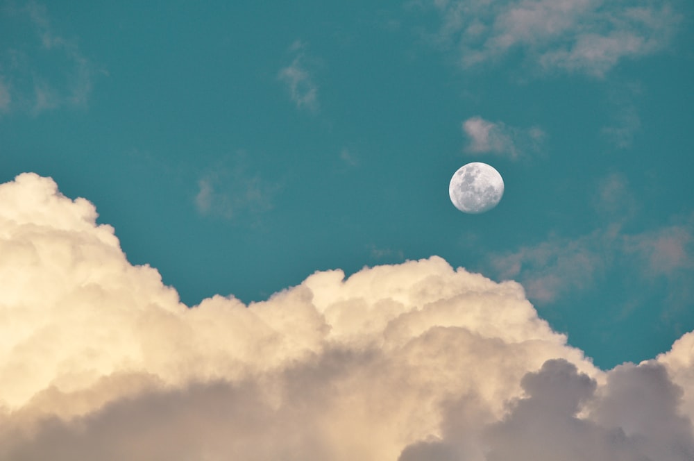low-angle photography of moon and clouds