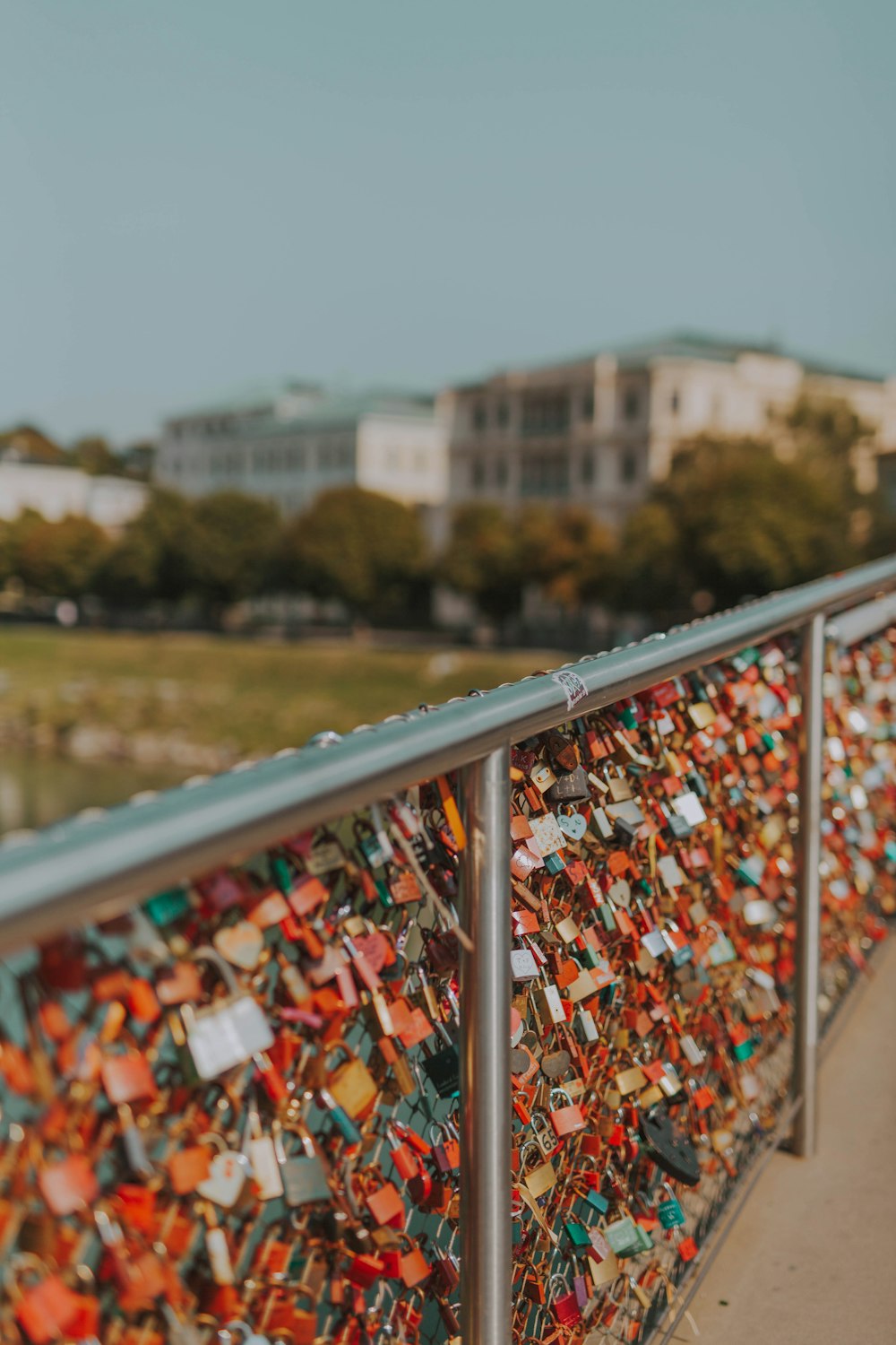 lot of padlocks in metal fence