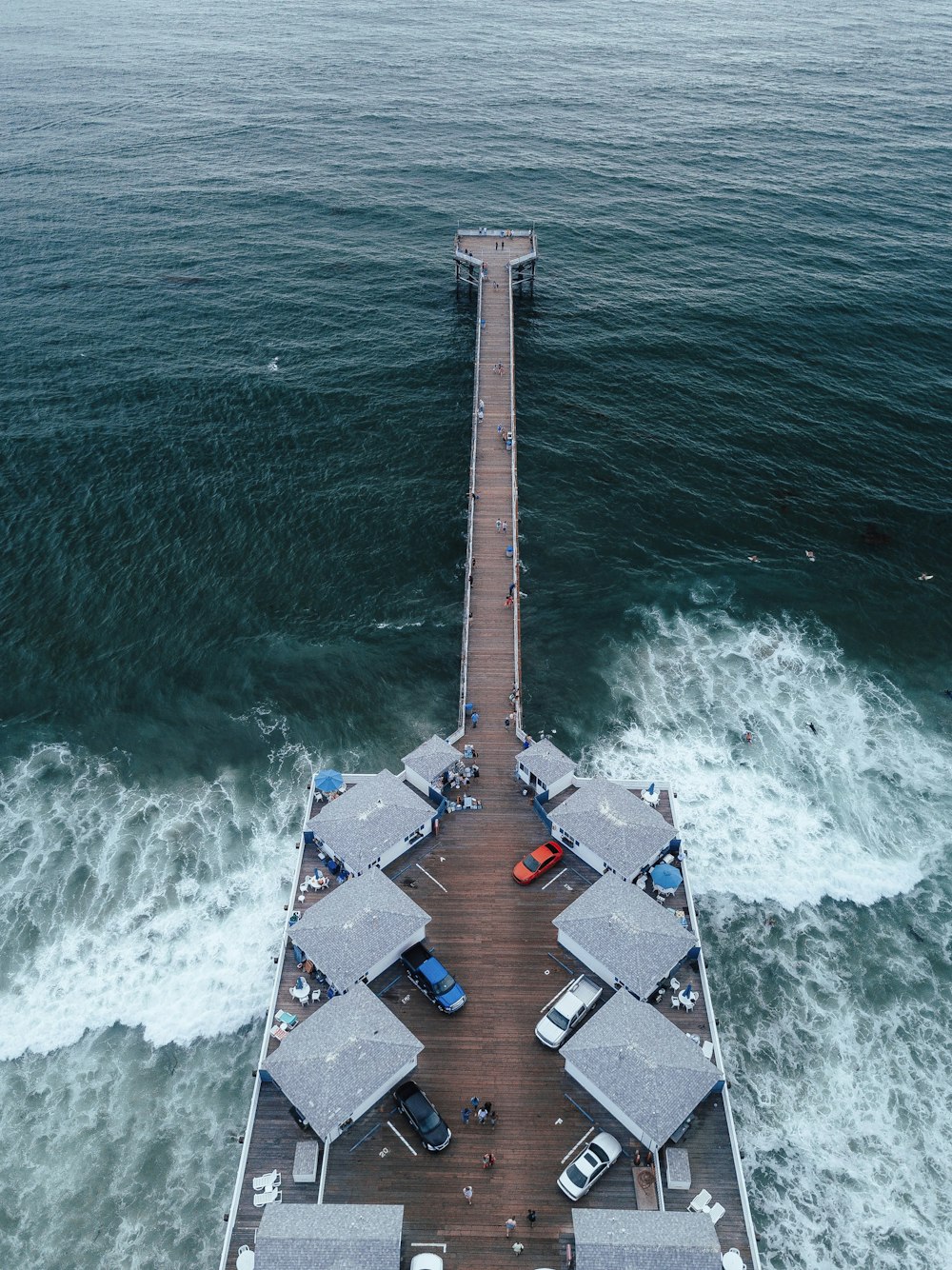 cars on park on brown wooden pathway on near sea