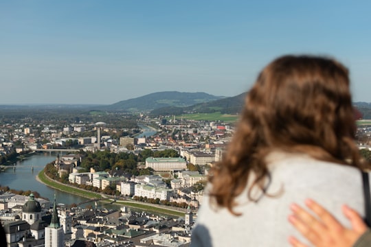 woman over viewing buildings during daytime in Fortress Hohensalzburg Austria