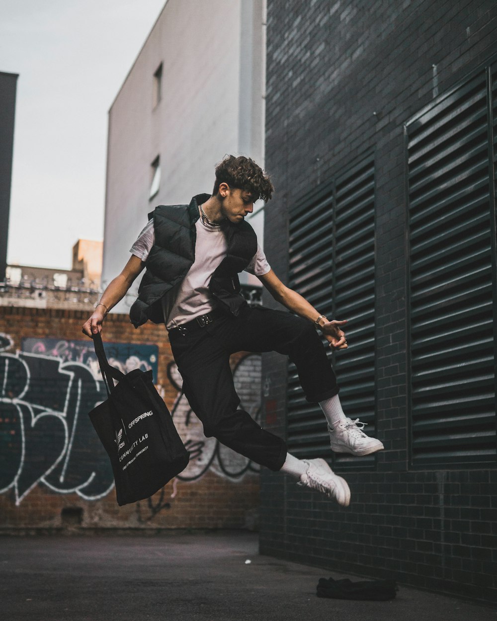 time lapse photography of man jumping carrying tote bag