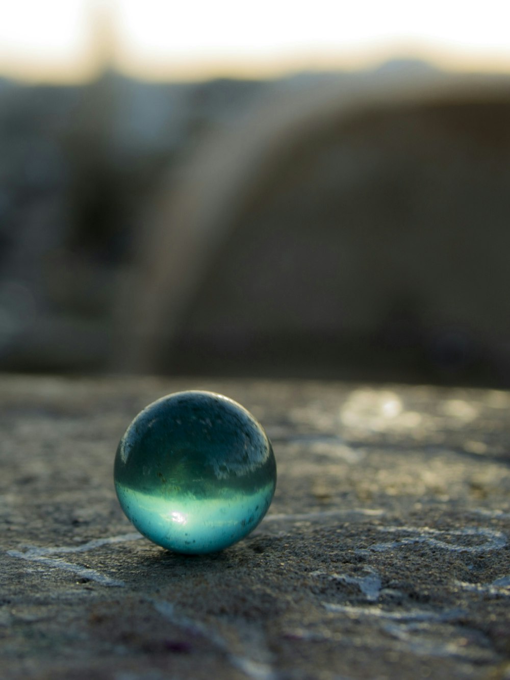 selective focus photo of clear glass marble toy