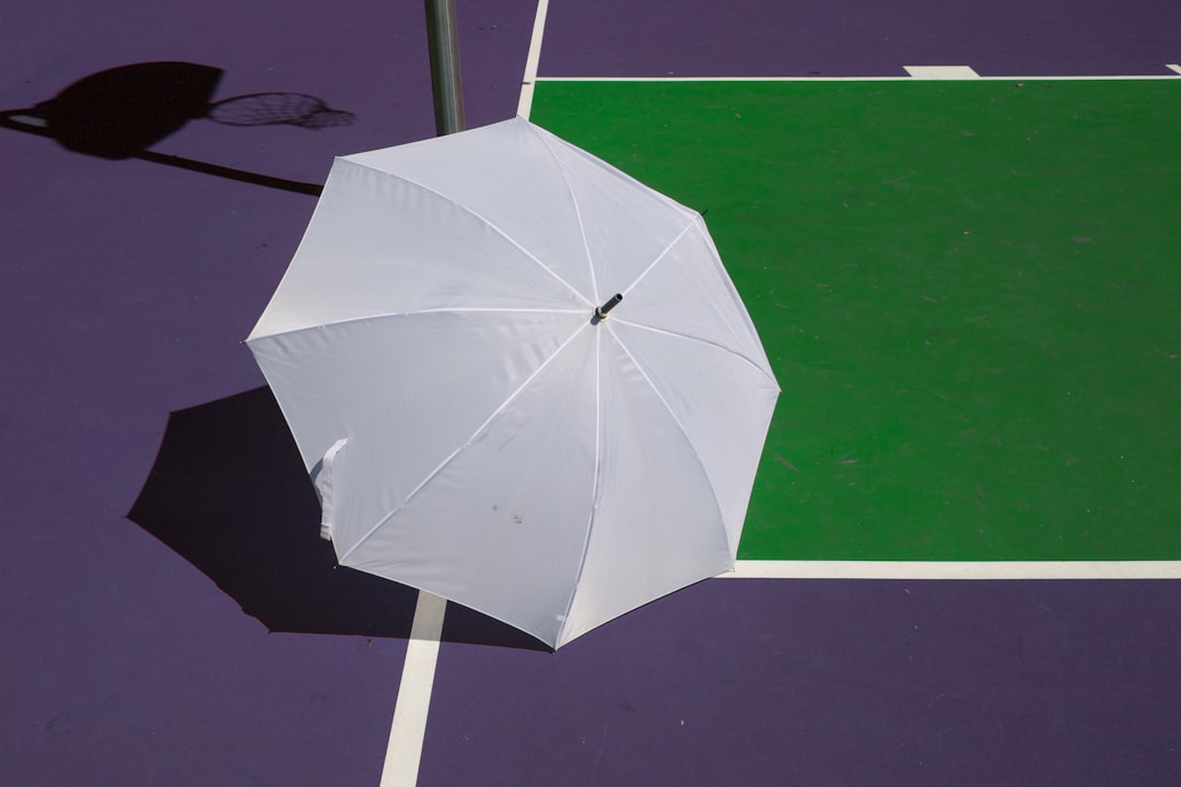 white umbrella purple surface