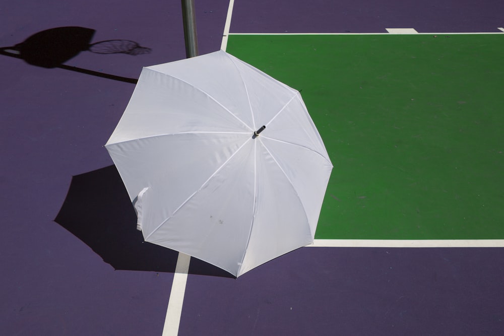 white umbrella purple surface