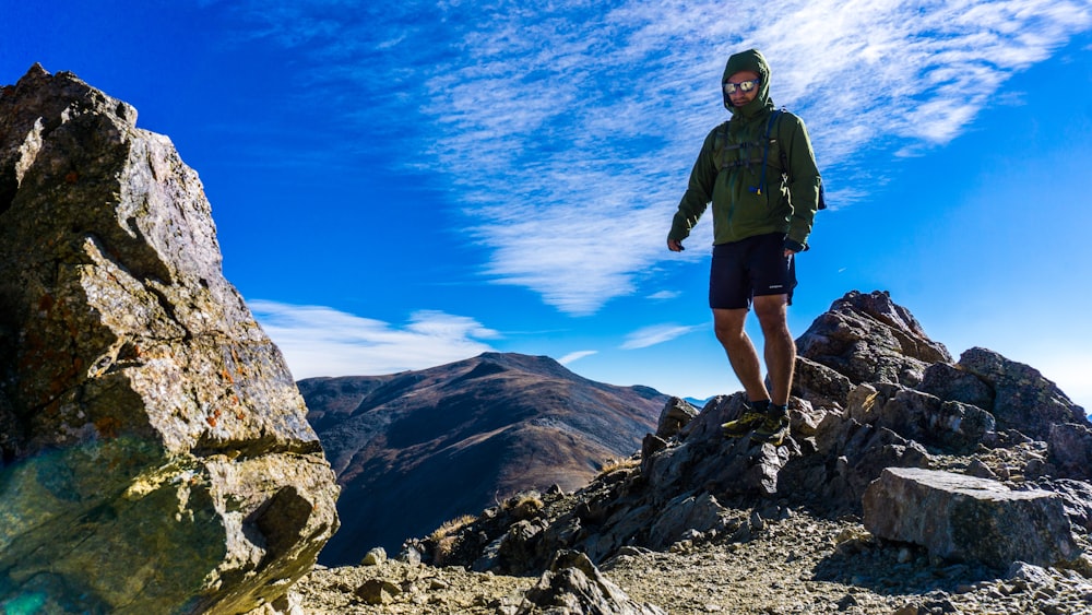 man walking on rock mountain