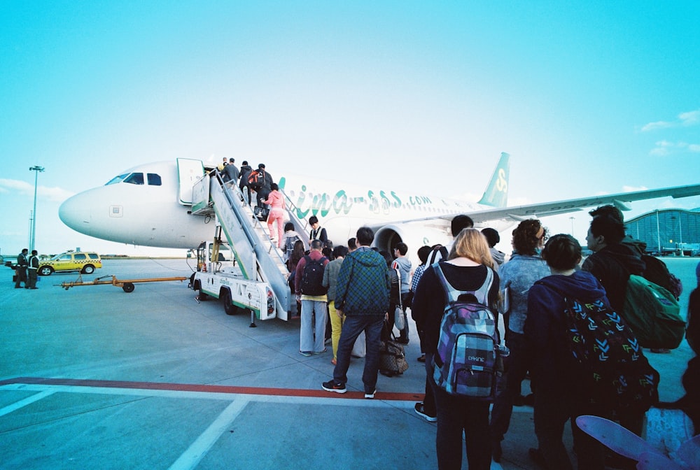 people about to enter plane during daytime