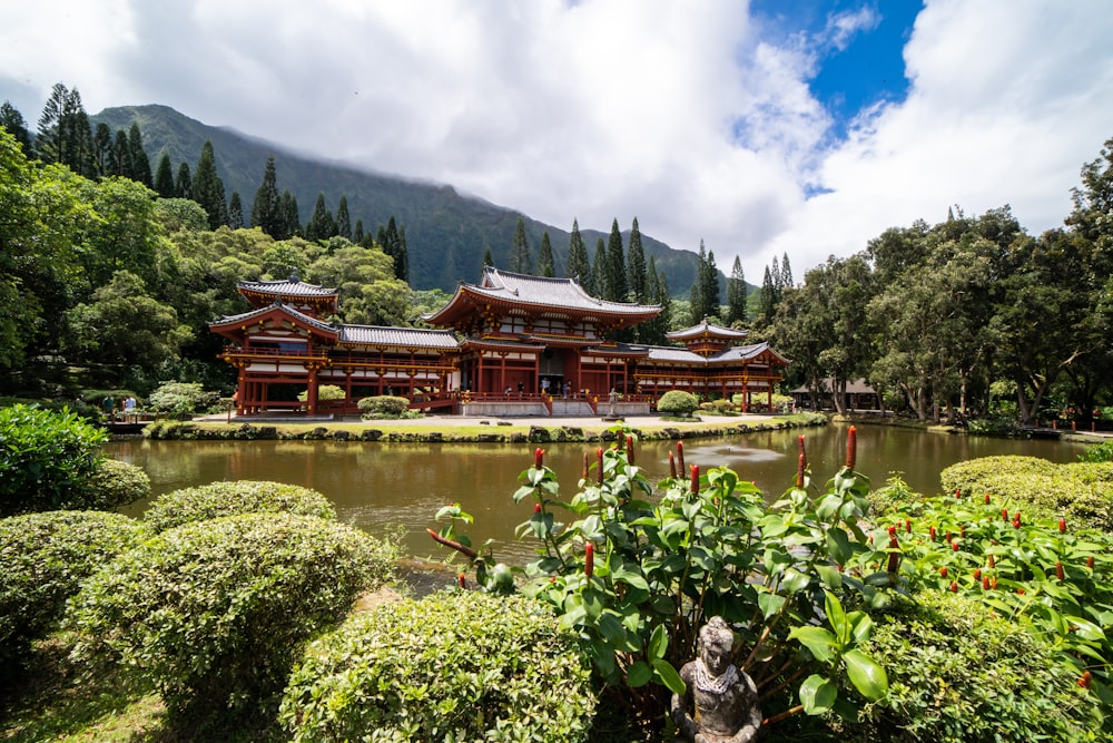 red paint temple near at body of water