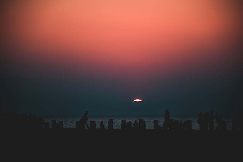 the sun is setting over the horizon of a city