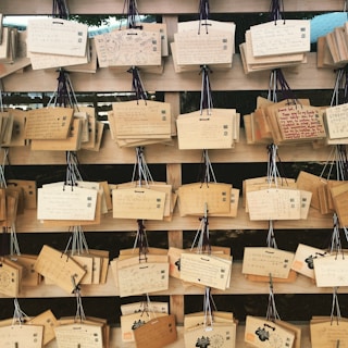 Several engraved wooden planks arranged artistically on a rustic table, highlighting different sweet texts.