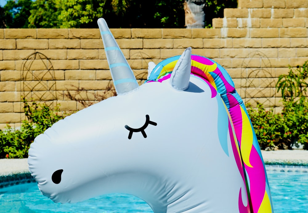 white and multicolored unicorn inflatable pool decor
