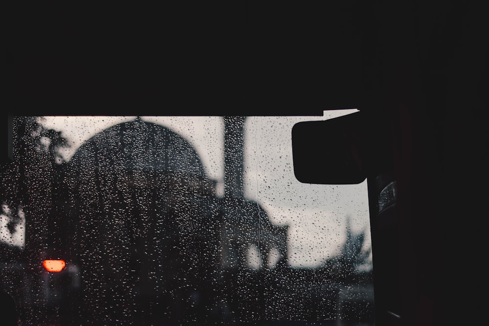 a view of a building through a rainy window