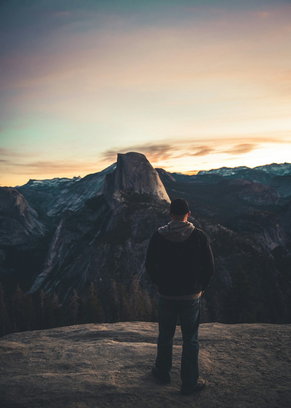 man standing on rock formation