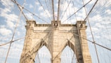 Time-lapse style photo of a bridge arch slowly rising against a clear sky.