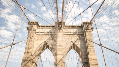 Time-lapse style photo of a bridge arch slowly rising against a clear sky.