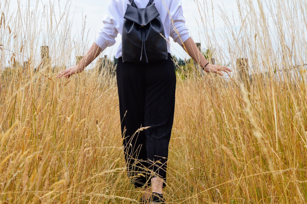 person walking on grass field