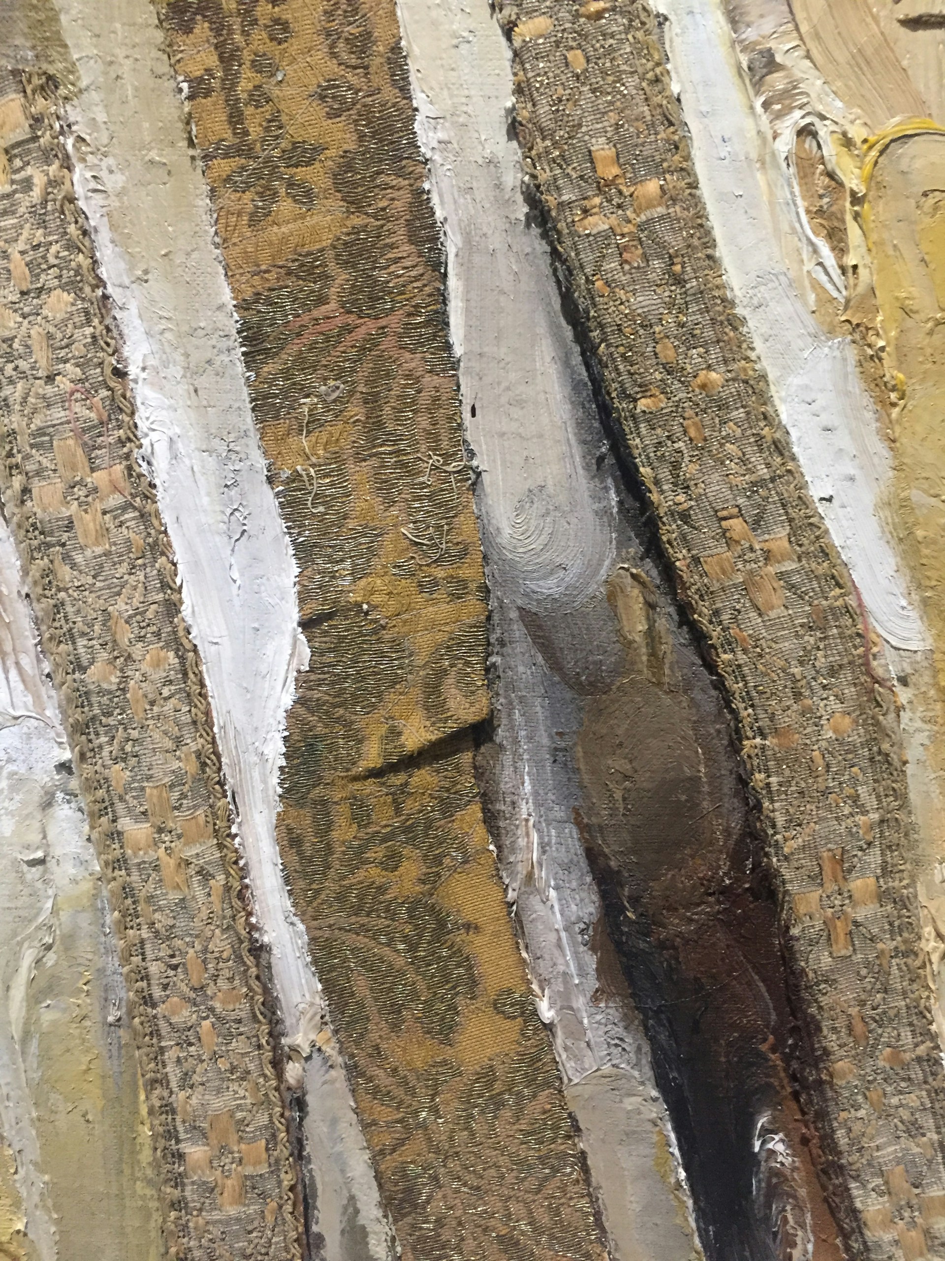 A close-up of a mixed-media artwork blending fabric, paint, and thread to create a rich tapestry of emotion and form.