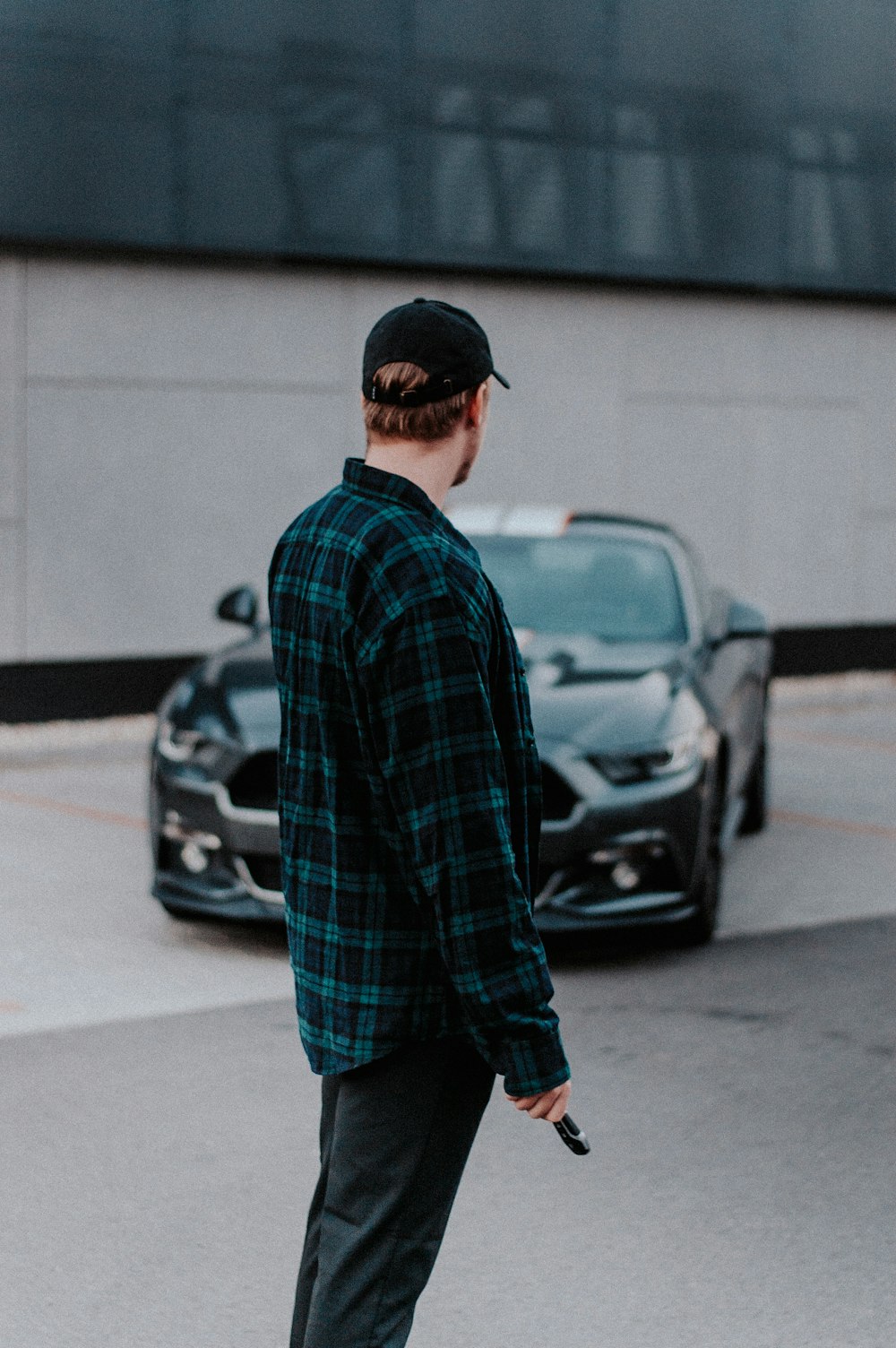 man standing near Ford Mustang coupe