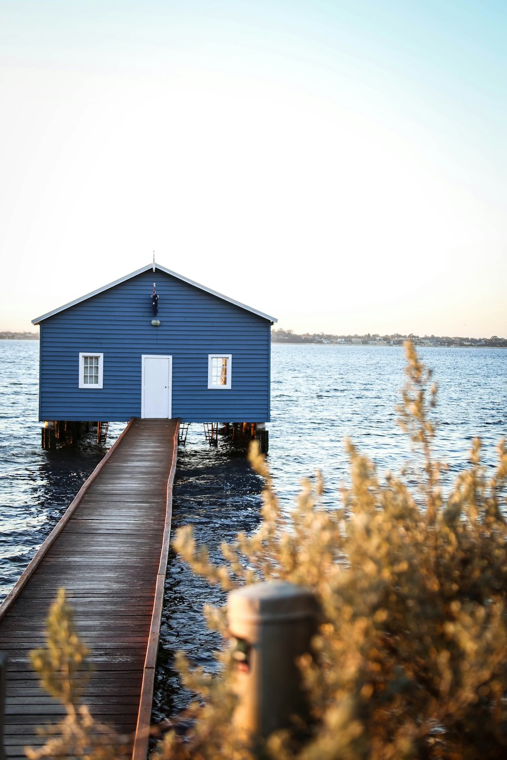 blue house with wooden dock