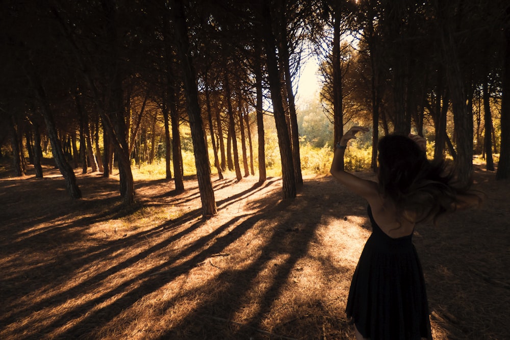 woman standing in forest