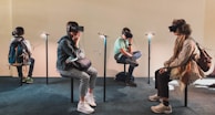 four person playing virtual reality goggles