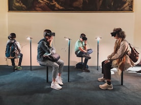 four person playing virtual reality goggles