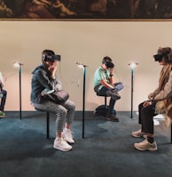 four person playing virtual reality goggles