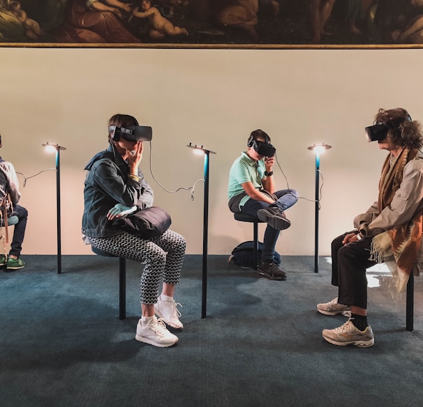 four person playing virtual reality goggles