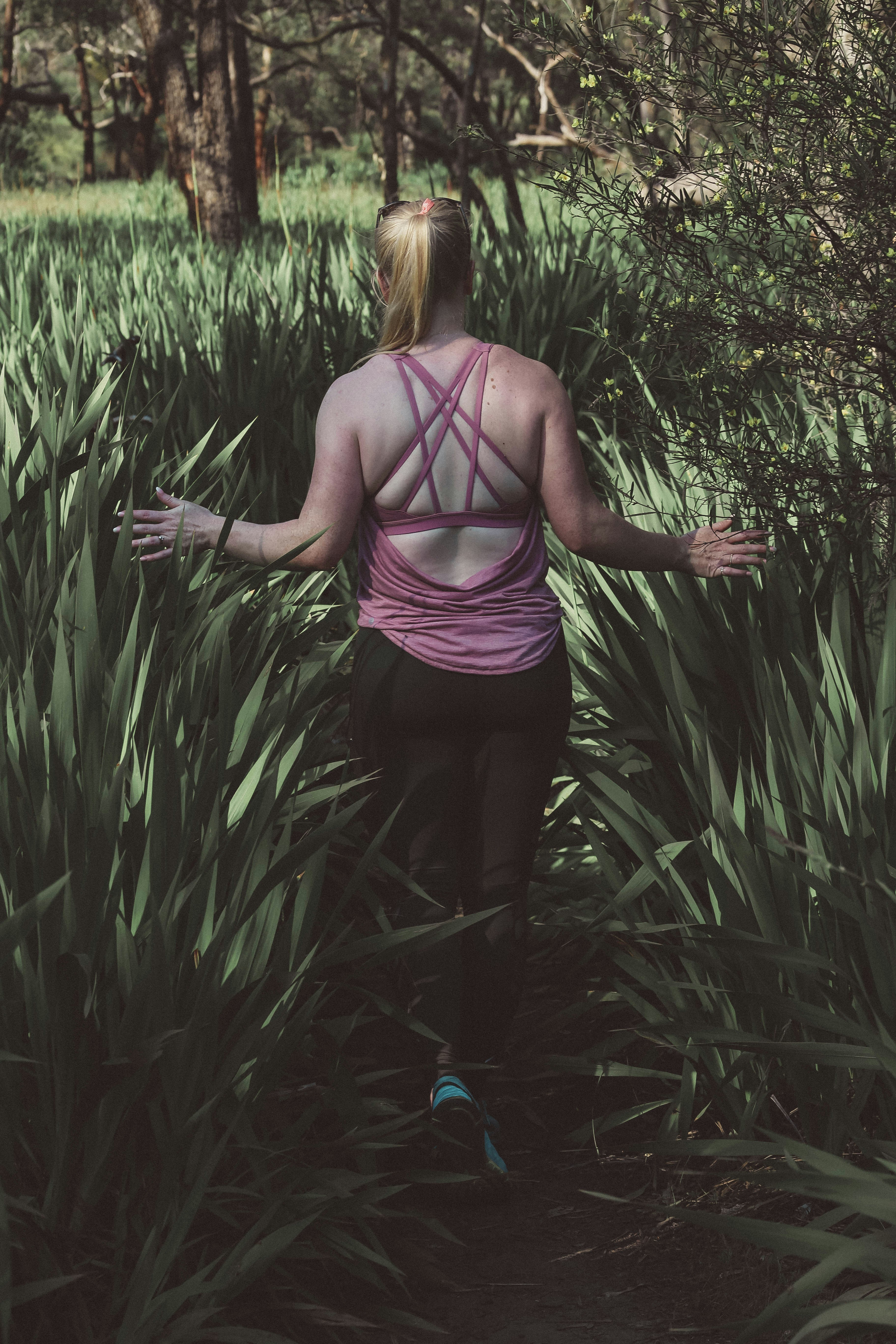 woman walking on grass field