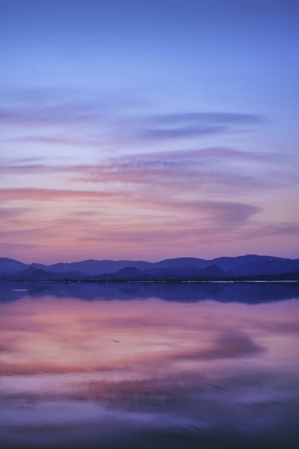 reflection of mountain on body of water