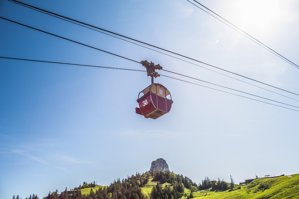 red cable car under sunlight