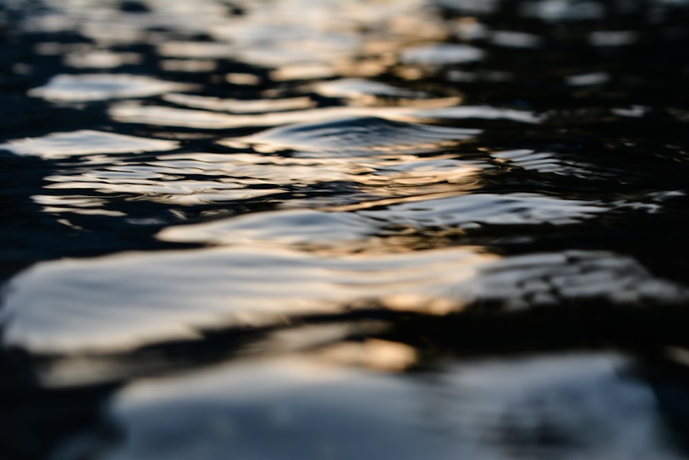 the water is reflecting the sky and clouds