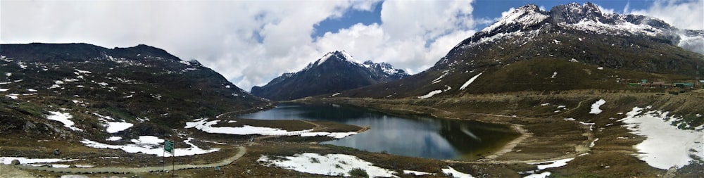 aerial photography of lake between valley and mountains